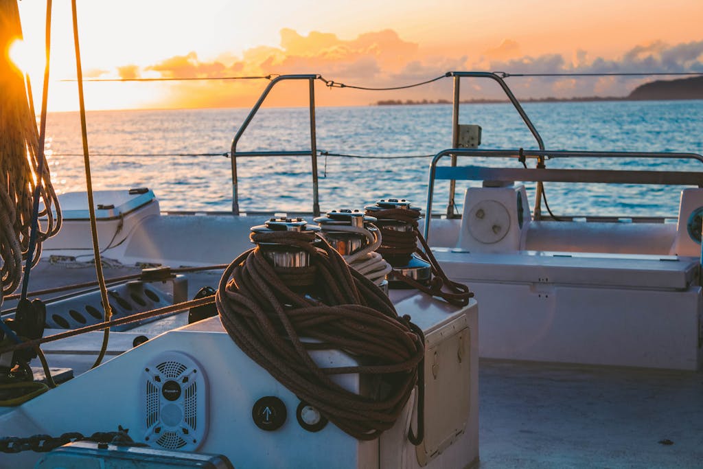 A serene view of a yacht deck during sunset in French Polynesia's Windward Islands.