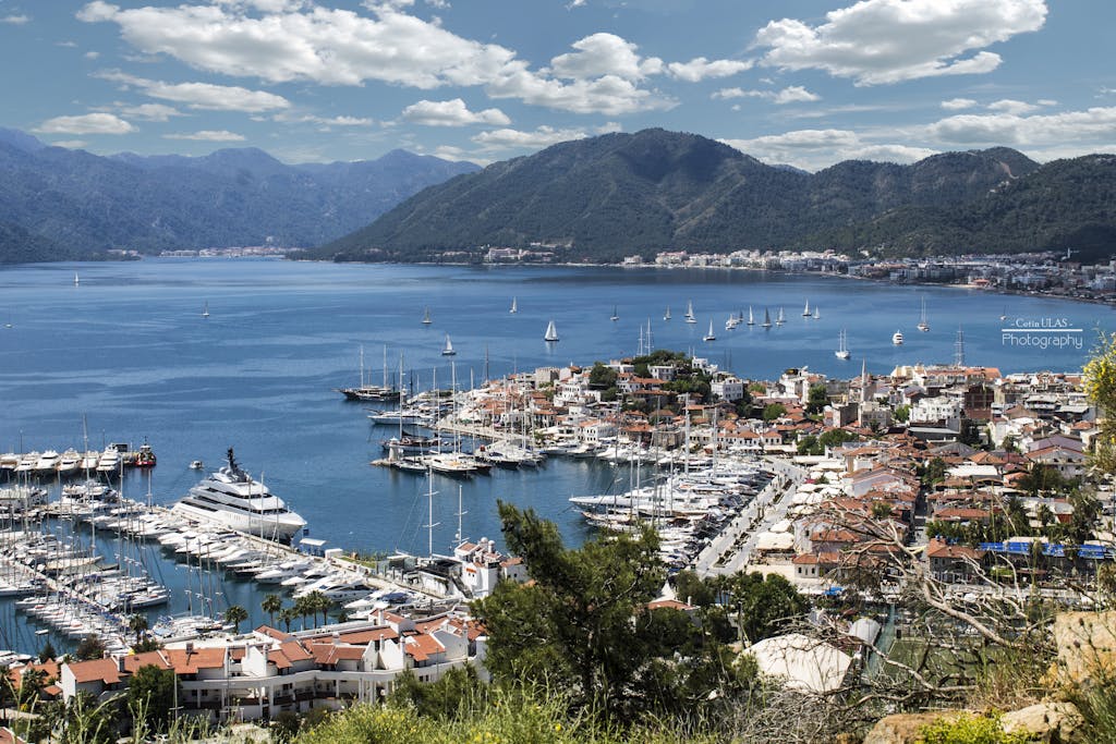 Breathtaking view of Marmaris harbor with yachts and sailboats under a clear sky.